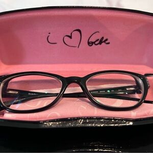 Black vintage BeBe glasses with pink interior case and cloth.